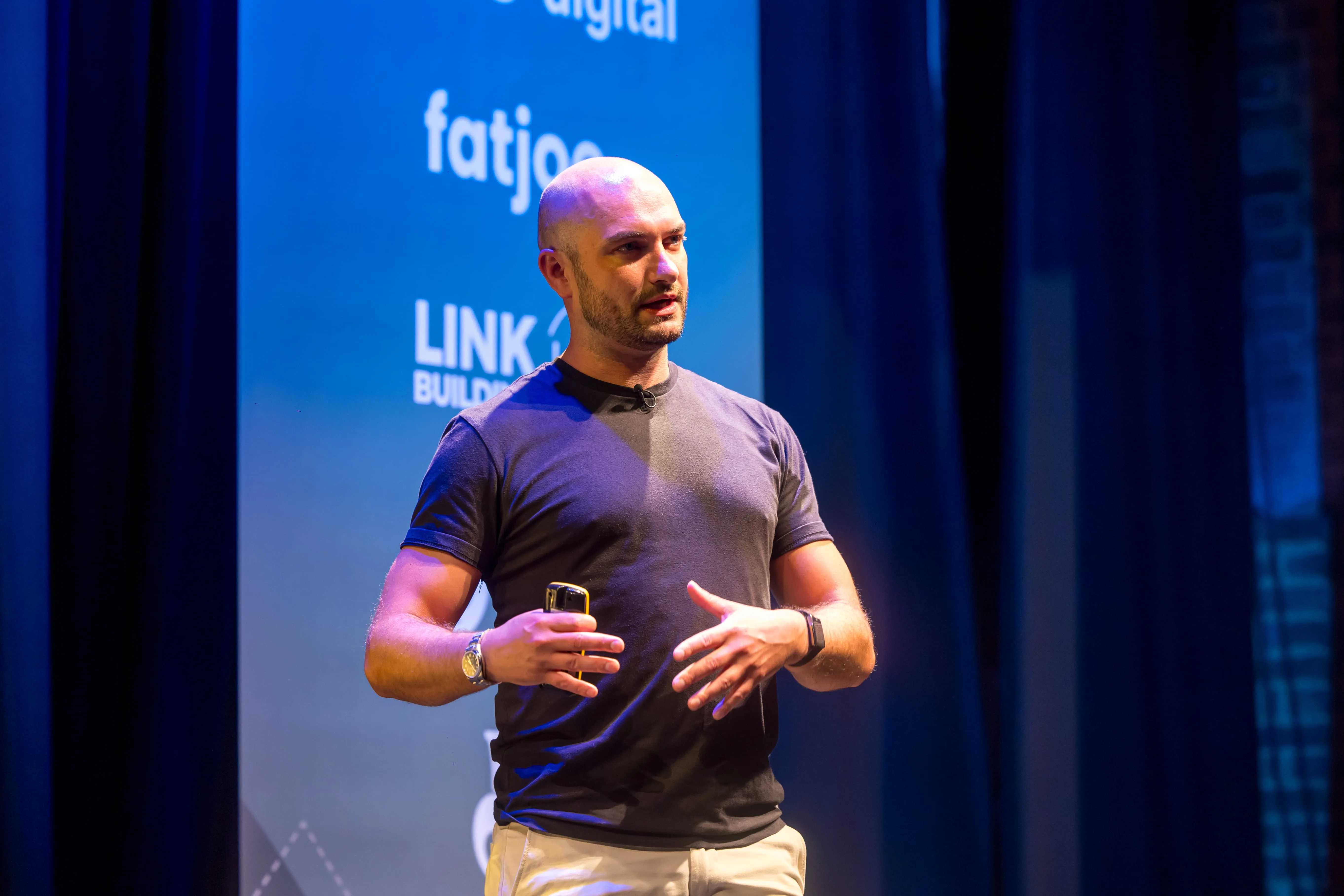 Andy Chadwick speaking on stage at a conference